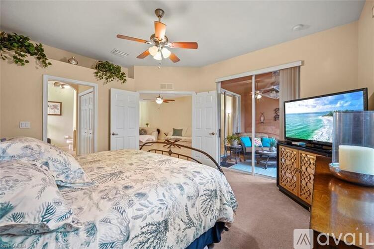 A bedroom with a large bed and a television.