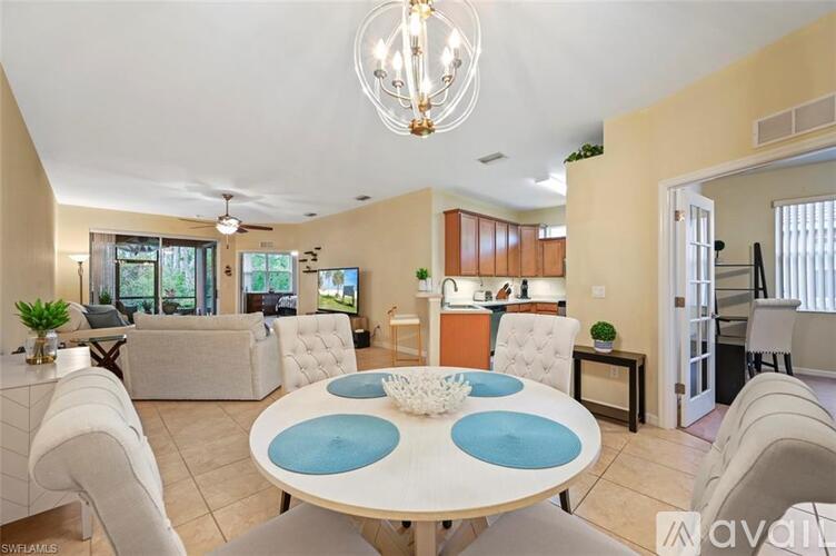 A modern dining room with a round table and chairs.