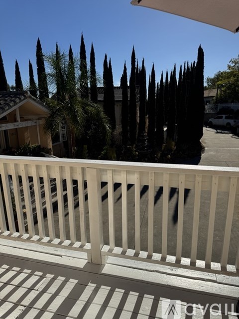 A white railing with a white umbrella above it.