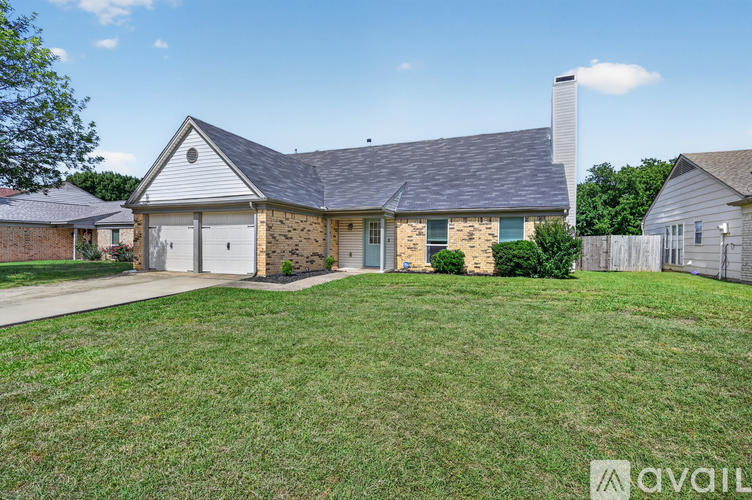 A house with a grey roof and a white chimney is for sale.