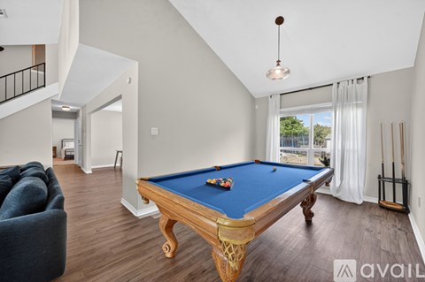A pool table in a room with a blue cloth.