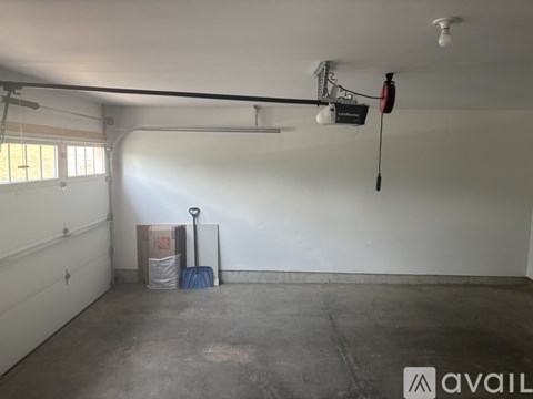 A room with a white wall and a concrete floor.