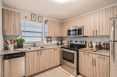 A kitchen with wooden cabinets and stainless steel appliances.
