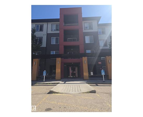 A building with a red section in the middle of it.