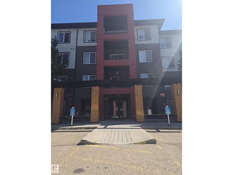 A building with a red section in the middle of it.