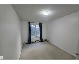 A room with a window and curtains.