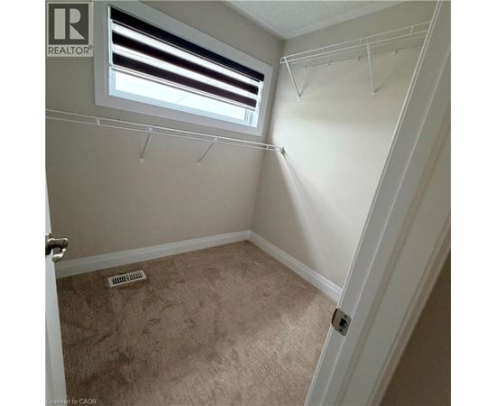 A small bedroom with a window and a door.