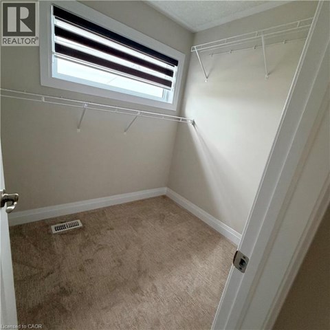 A small bedroom with a window and a door.