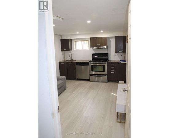 A kitchen with a stove top oven and a dishwasher.