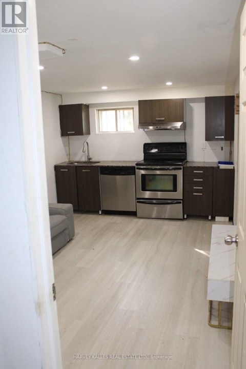 A kitchen with a stove top oven and a dishwasher.