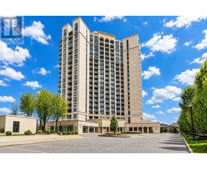A tall building with a parking lot in front of it.