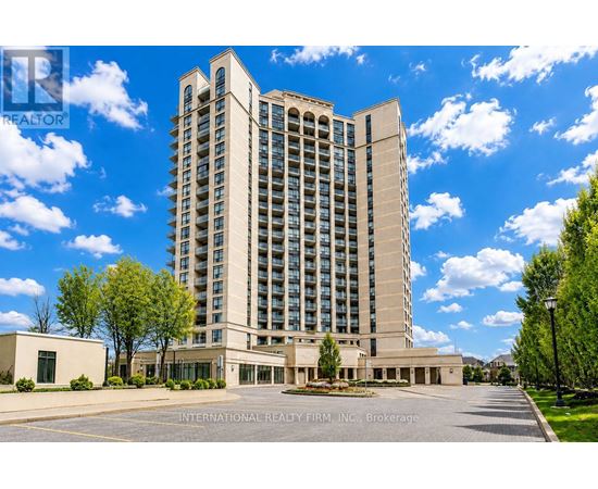 A tall building with a parking lot in front of it.