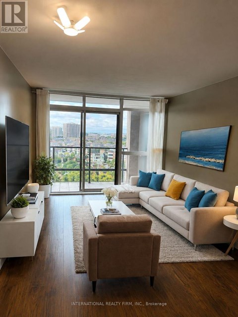 A living room with a couch, a chair, a television, and a large window with a view of the city.