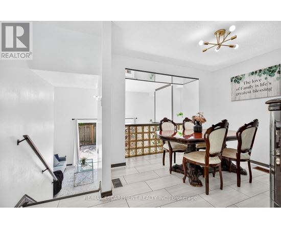 A dining room with a glass table and chairs.