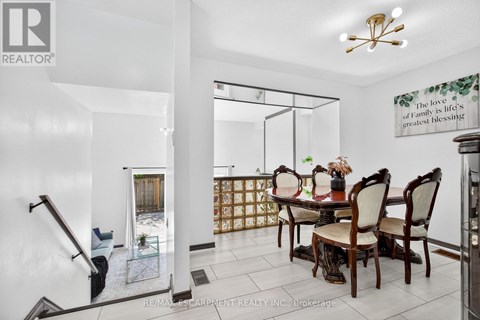 A dining room with a glass table and chairs.