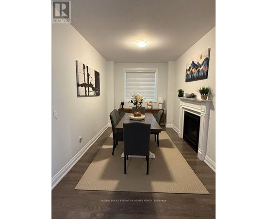 A dining room with a table set for four.
