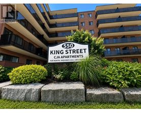 A sign for 550 King Street stands in front of a building.