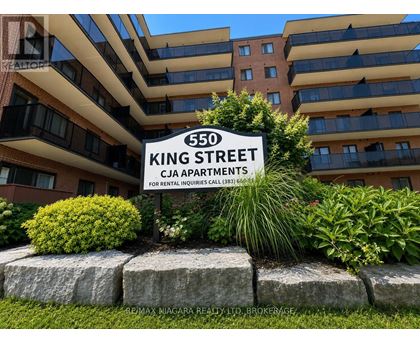 A sign for 550 King Street stands in front of a building.