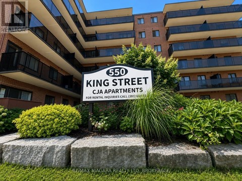 A sign for 550 King Street stands in front of a building.