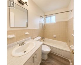 A bathroom with a sink, toilet, and bathtub.
