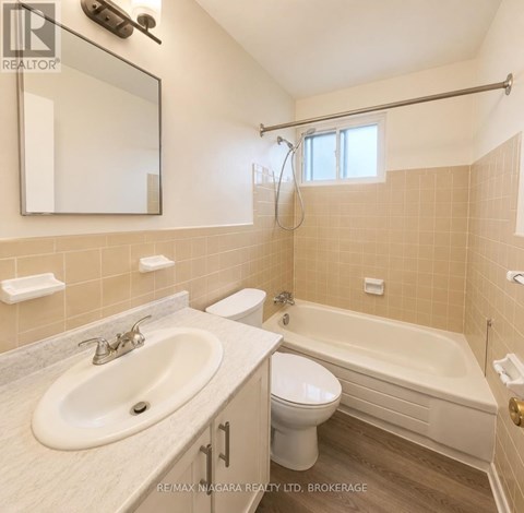 A bathroom with a sink, toilet, and bathtub.