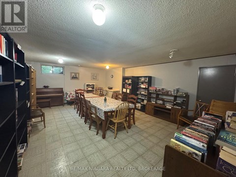 A living room with a dining table and chairs.