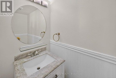 A bathroom with a sink and a mirror.
