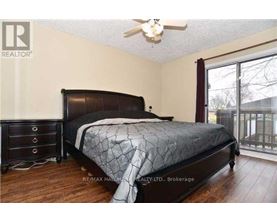 A bedroom with a large bed and a ceiling fan.