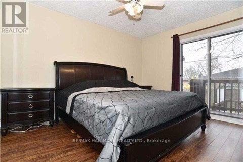 A bedroom with a large bed and a ceiling fan.