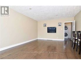 A living room with a flat screen TV mounted on the wall.