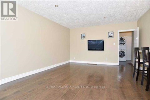 A living room with a flat screen TV mounted on the wall.