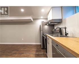 A kitchen with a wooden counter top and stainless steel appliances.