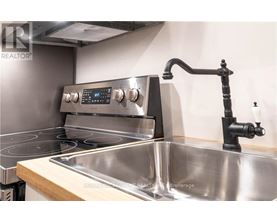 A modern kitchen with a stainless steel oven and sink.