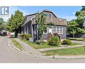 A house with a grey facade is for sale.