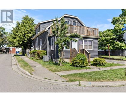 A house with a grey facade is for sale.