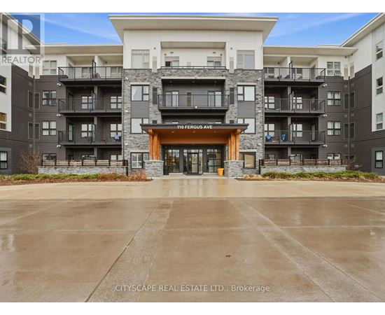 The image shows a multi-story residential building with a large entrance and balconies.