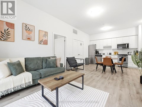 A modern living room with a green couch and a wooden coffee table.