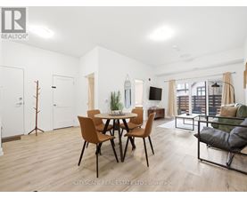 A modern dining room with a wooden table and chairs.