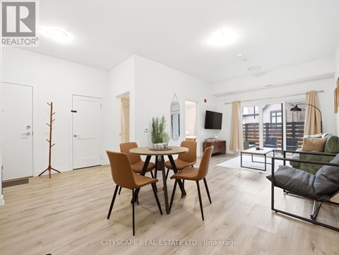 A modern dining room with a wooden table and chairs.