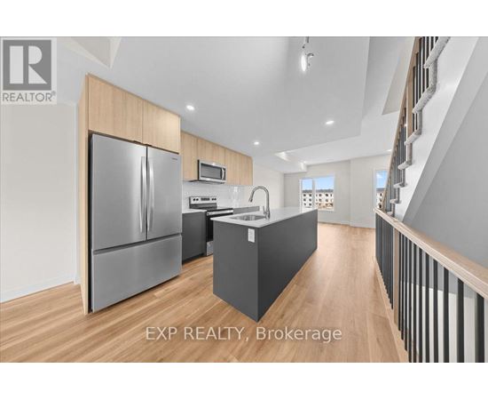 A modern kitchen with wooden cabinets and a stainless steel refrigerator.