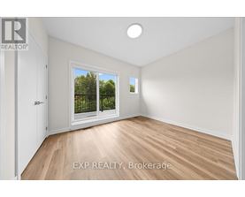 A room with EXP REALTY, Brokerage written on the floor.