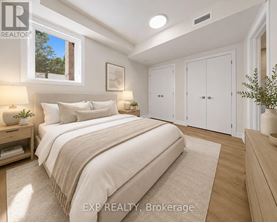 A bedroom with a large bed and a window.