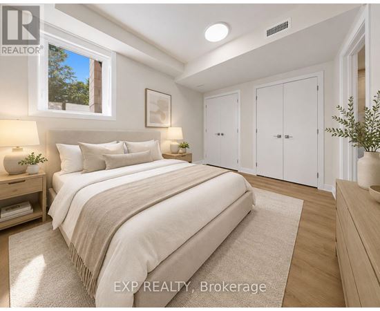 A bedroom with a large bed and a window.