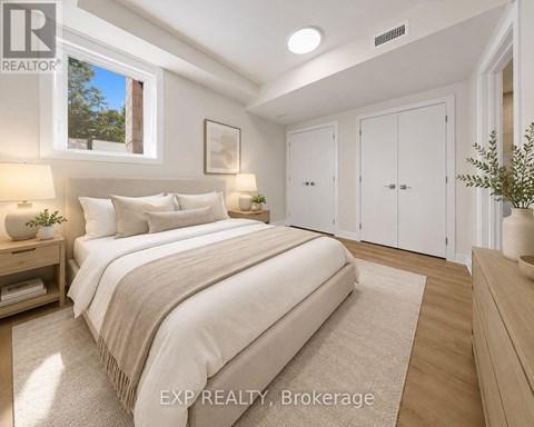 A bedroom with a large bed and a window.