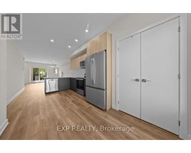 A kitchen with white cabinets and a wooden island.