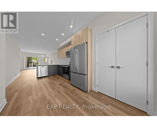 A kitchen with white cabinets and a wooden island.