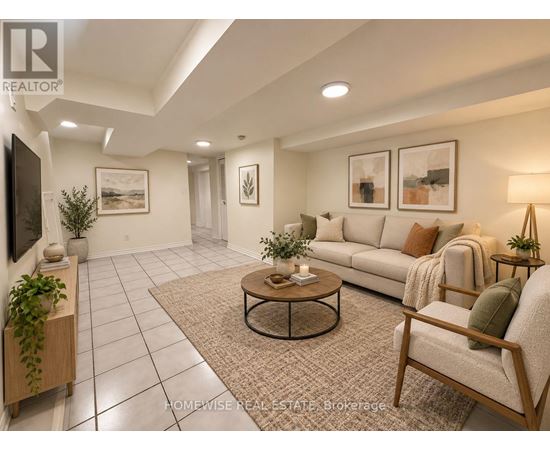 A living room with a couch, chair, and potted plants.