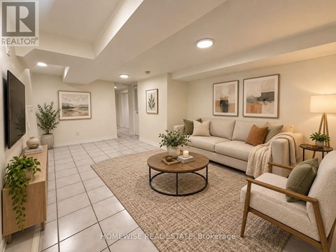 A living room with a couch, chair, and potted plants.