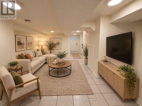 A living room with a white sofa, a wooden chair, a coffee table, and a flat-screen TV.