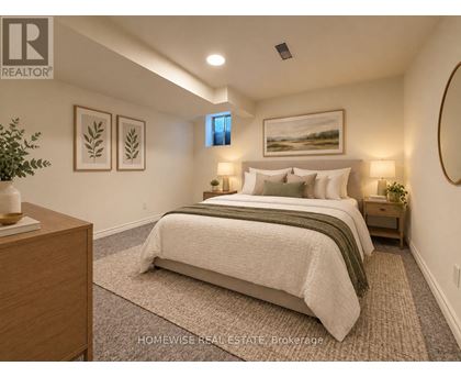 A bedroom with a large bed and a painting on the wall.